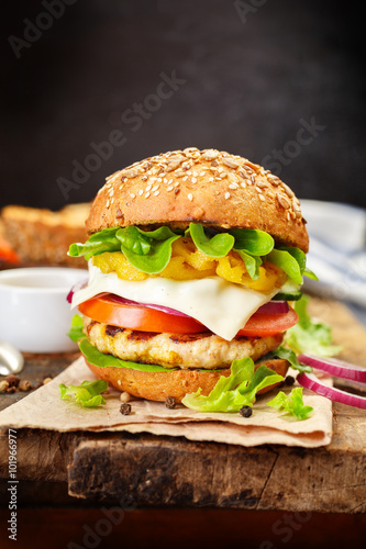 Healthy chicken hamburger, whole grain bun with fresh vegetables