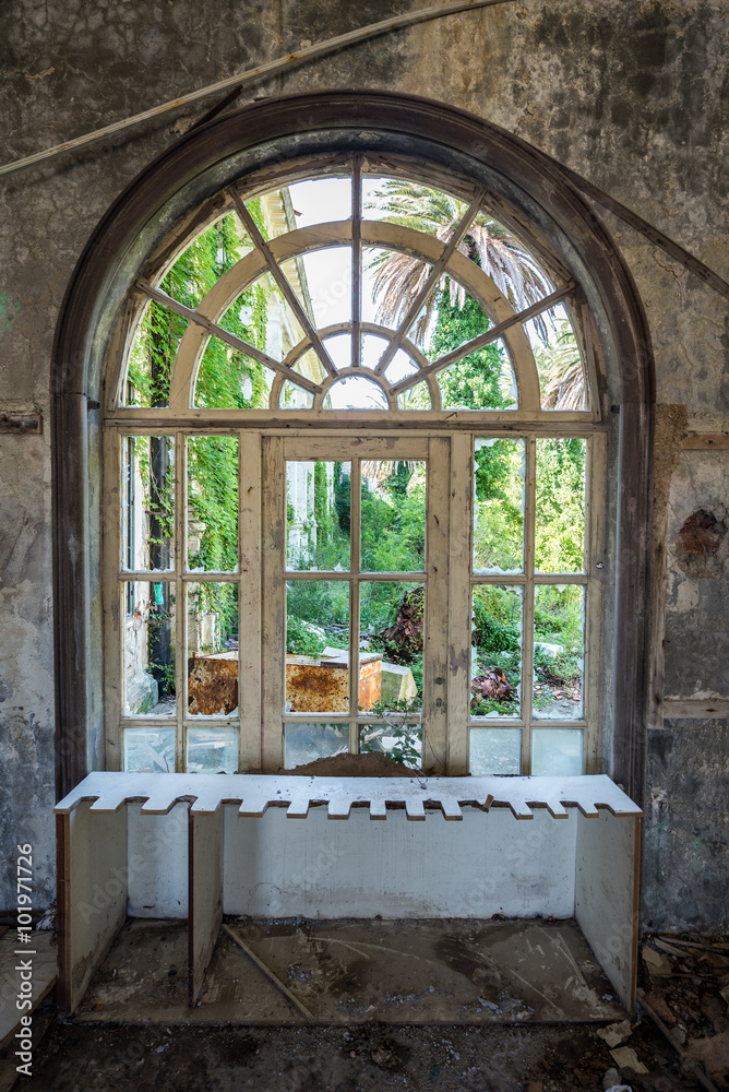 window in old abandoned hotel in former Tourist Complex of Kupari village, Croatia