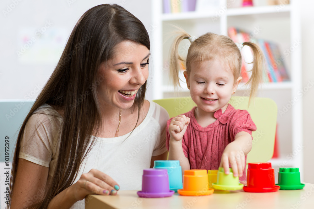 cute mother and her daughter child playing together indoor cute mother and her daughter child playing together indoor