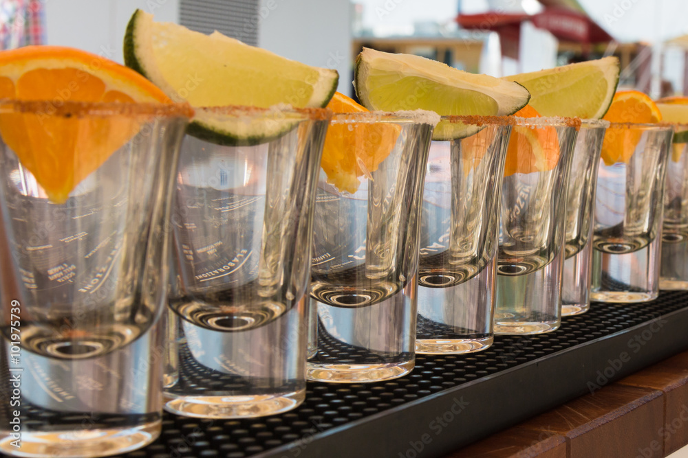 Little Glasses in Line with Orange and Lime Slices Ready to Tequ Little Glasses in Line with Orange and Lime Slices Ready to Tequ