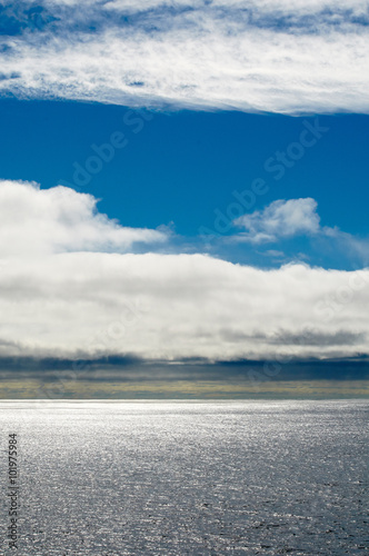Seascape with blue sky and white clouds