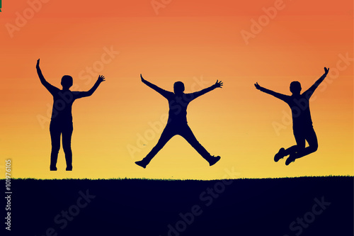 The silhouette of three people jumping with orange background,concept of happiness, joy, joyful life