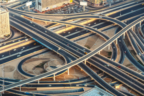 Aerial view of highway junction with little traffic in Dubai, UAE, at sunset. Famous Sheikh Zayed road in Dubai downtown. Transportation and driving concept. photo