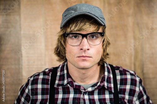 Serious blond hipster staring