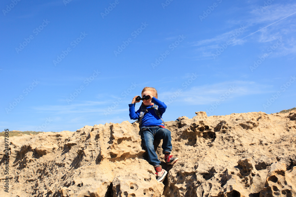 little boy looking through binoculars while travel little boy looking through binoculars while travel