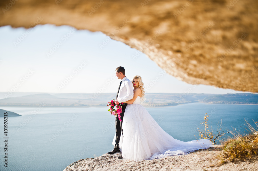 Charming bride and elegant groom on landscapes of mountains, wat Charming bride and elegant groom on landscapes of mountains, wat