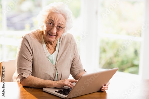 Smiling senior woman using laptop