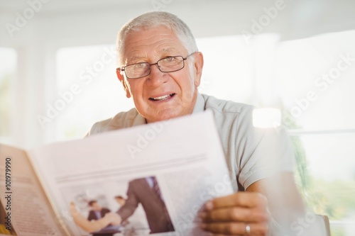Focused senior man reading newspaper