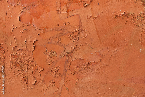 Old terracotta painted stucco wall with chipped paint. Backgroun photo