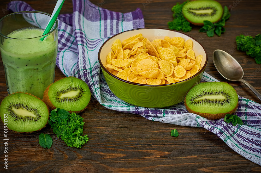 Cornflakes with kiwi smoothie. Cornflakes, fresh fruit and kiwi detox on a  wooden background. Close-up. Selective focus. Stock Photo | Adobe Stock