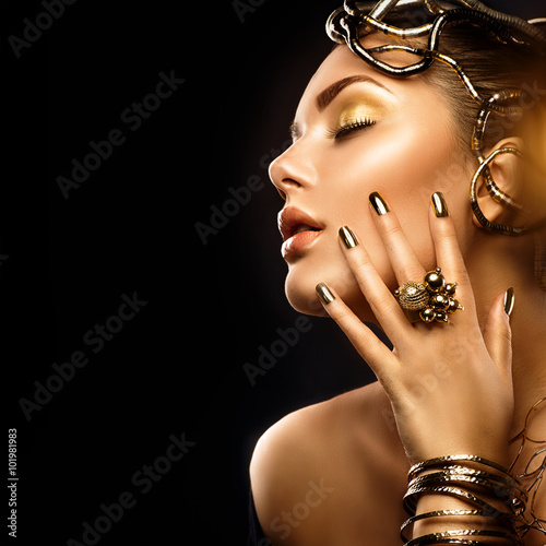 Beauty fashion woman with golden makeup, accessories and nails