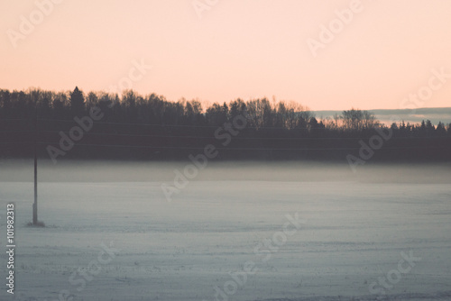 foggy country fields in winter on cold morning - vintage effect