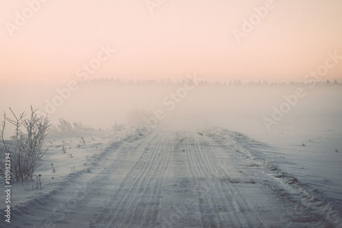 foggy country fields in winter on cold morning - vintage effect