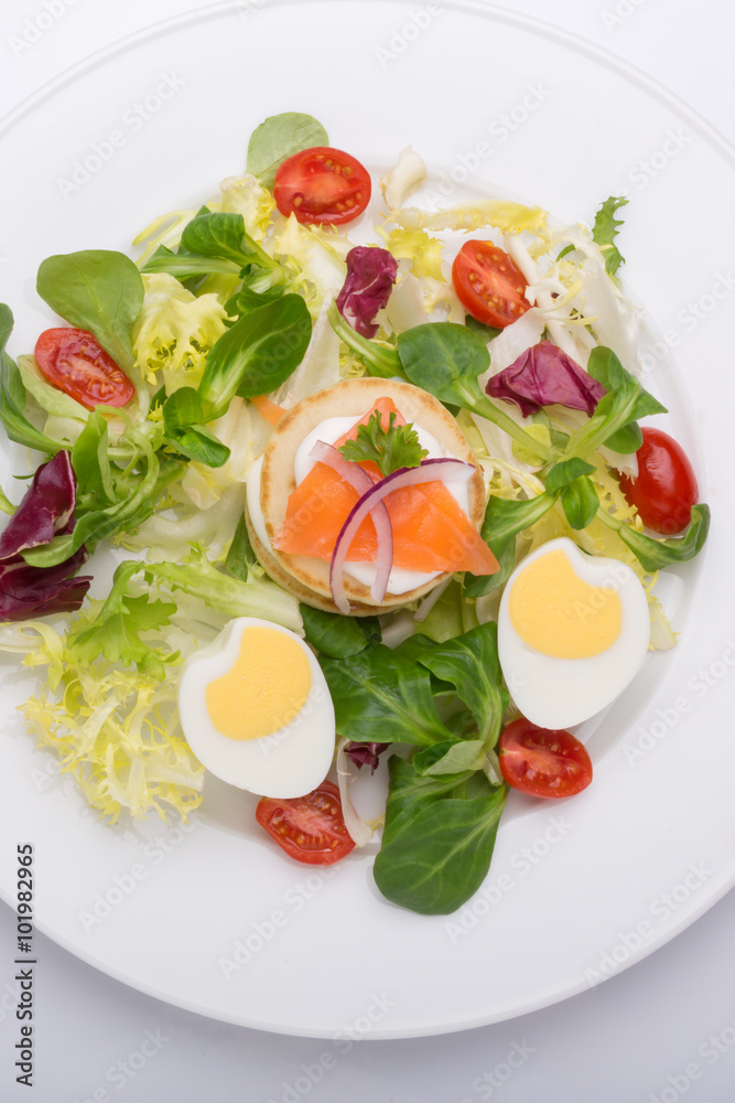 green salad with eggs in the shape of a heart, salmon, cherry tomatoes green salad with eggs in the shape of a heart, salmon, cherry tomatoes