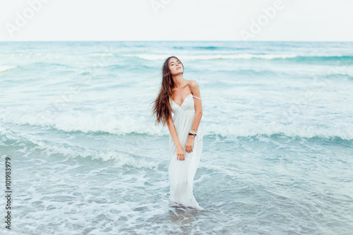 Freedom concept,Beautiful sexy young woman brunette hair evening makeup wearing short dress suit top skirt,tropical island LA,California.walks summer fall collection,perfect outfit in ocean view