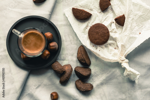 breakfast representation on white background with coffee espresso,chocolate biscuits, walnuts,hazelnuts,almonds,brazilian nuts and nutcracker, filtered with vintage colors © aledesun