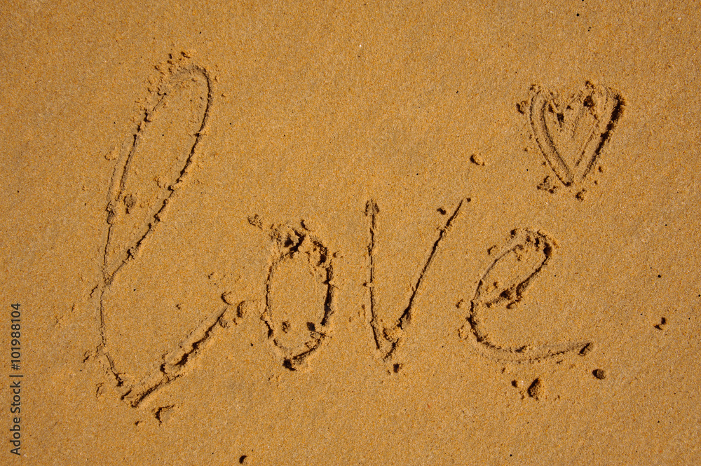 love word written on brown sand
