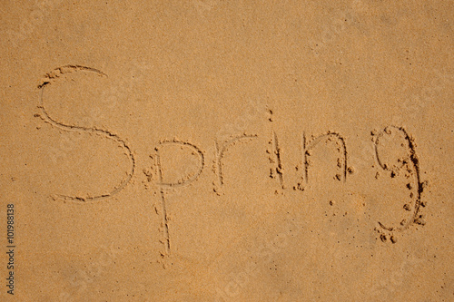 Conceptual photo of word spring written on a sand
