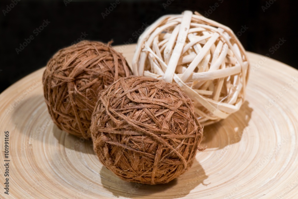 Three Woven Wickers or Bamboo Balls on A Wooden Tray