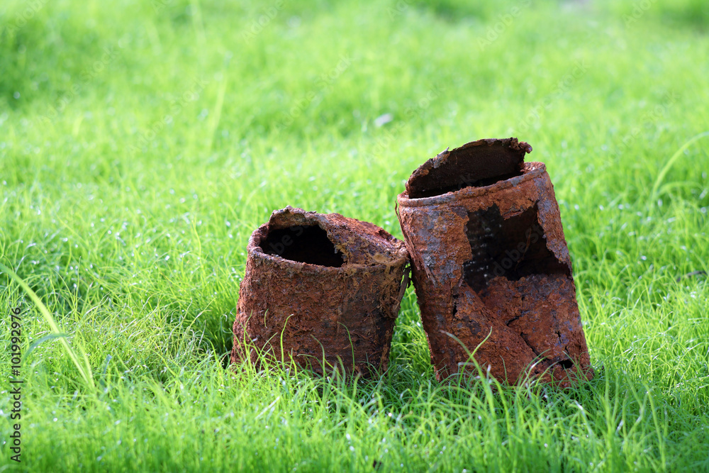 couple of rusty can on young grass,like a sign of 