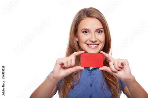 Confident business woman in glasses showing blank credit card