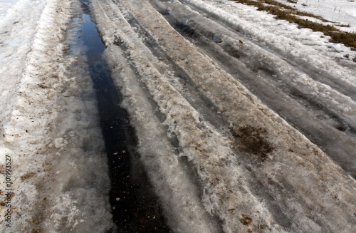 Dirty asphalt road in snow
