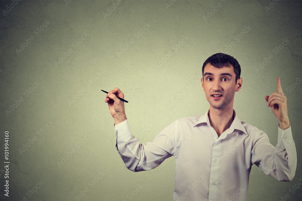 Portrait young creative man drawing, template for illustration on gray wall background Portrait young creative man drawing, template for illustration on gray wall background
