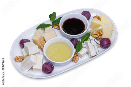 Different types of cheese on a white long plate
