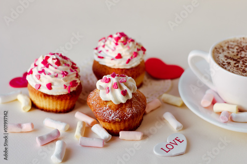 Beautiful coffee Cup with heart cupcake on white wooden background
