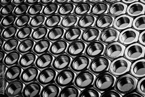 Obraz na płótnie Nut screws tightly stacked next to each other on a flat surface. Nut background isolated on white. w salonie