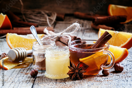 Warming black tea with honey, cinnamon and orange in a glass cup