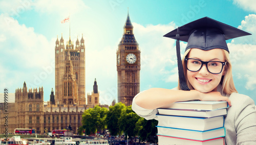 Canvas Print student in trencher cap with books over london