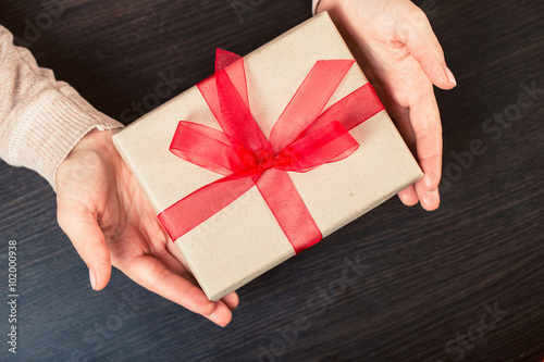 girl holding a gift box. Manicure gel nail photo