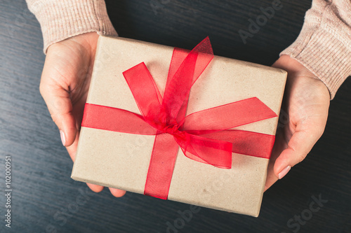 girl holding a gift box. Manicure gel nail photo