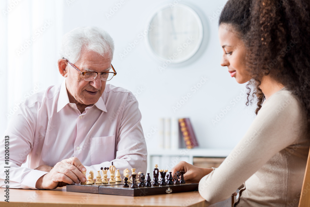 Retired man playing chess Retired man playing chess