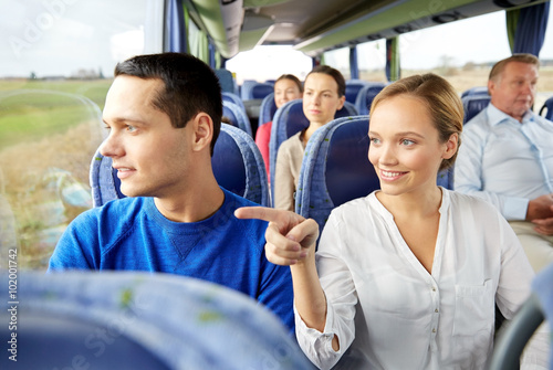 happy couple or passengers in travel bus