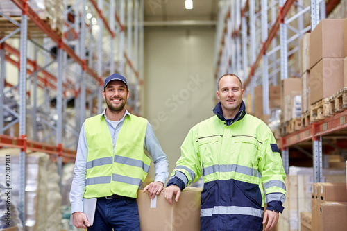 men in uniform with boxes at warehouse