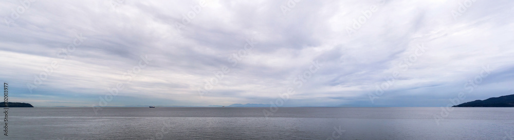 panoramic view of the coast of british columbia with vancouver island on the horizon and two tanker ship