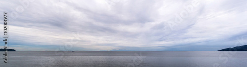 panoramic view of the coast of british columbia with vancouver island on the horizon and two tanker ship