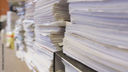 Piles of documents stored in the office. Bureaucracy and paperwork concept. 
