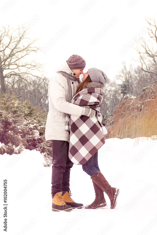 Happy couple in love in park in winter with light leaks