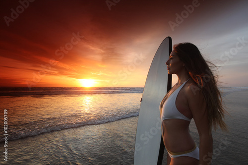 Surfer girl on beach at sunset © yellowj