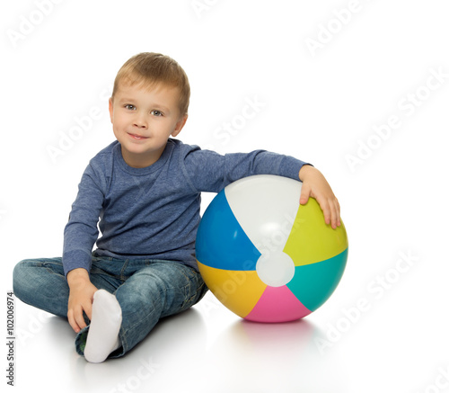 Little boy hugging the ball