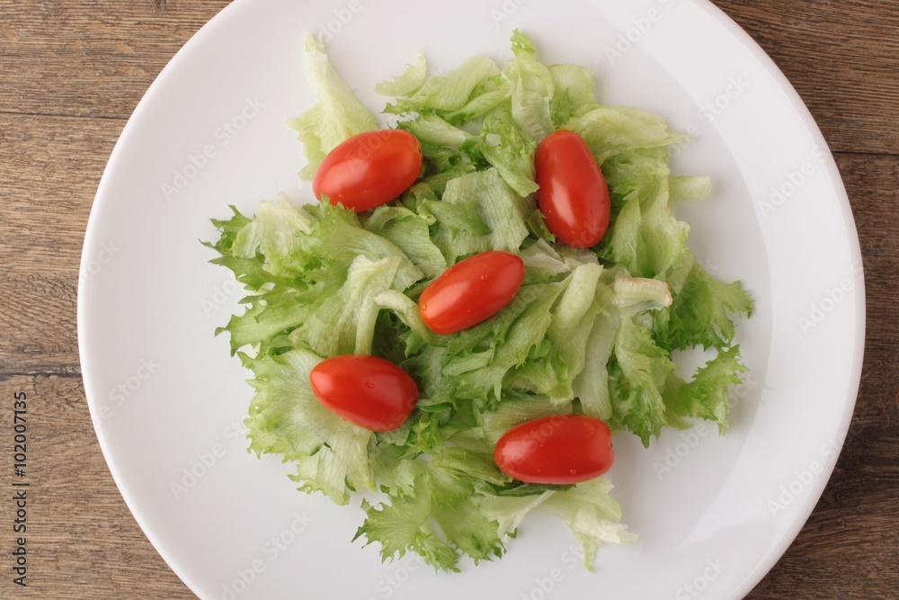 Fresh salad on a wooden background