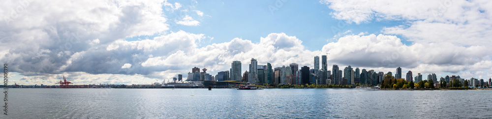 skyline of vancouver city behind the sea during a sunny day of summer with a beautiful sky seen from stanley park british columbia canada 