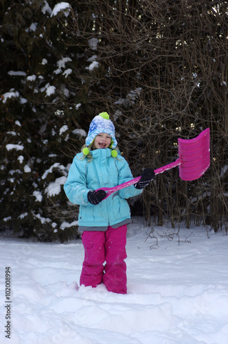young girl with snow shovel 