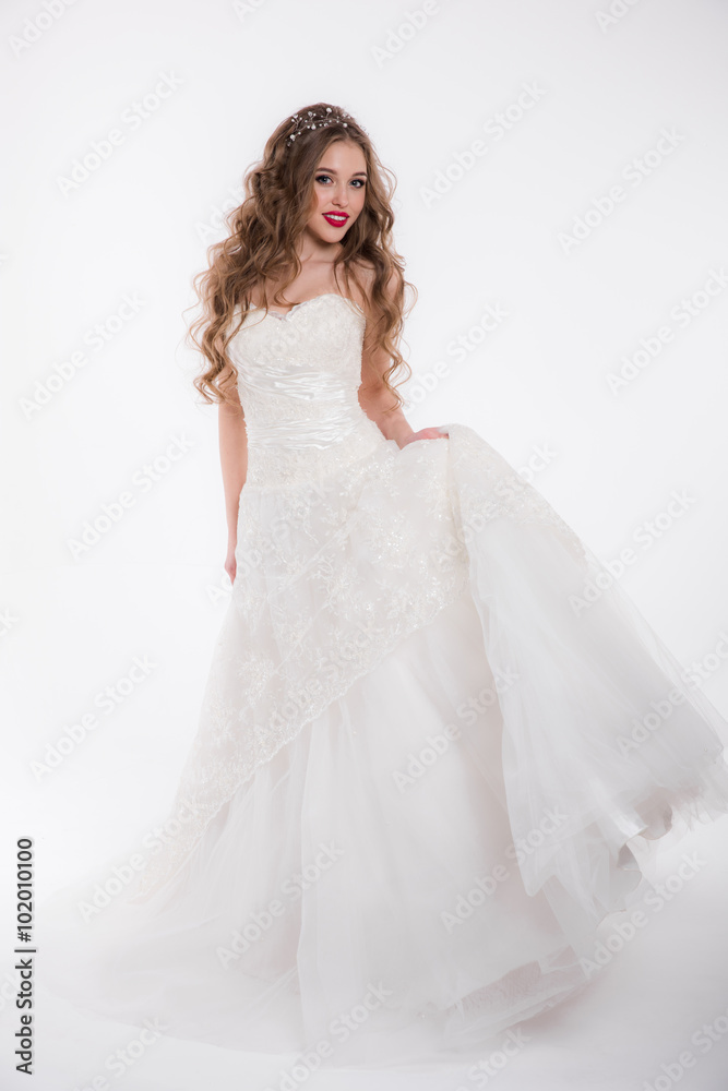 Beautiful girl in a wedding dress isolated on white Beautiful girl in a wedding dress isolated on white
