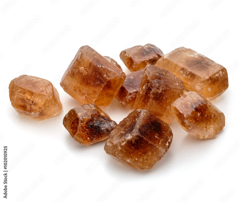 Brown caramelized lump cane sugar cube isolated on white backgro Brown caramelized lump cane sugar cube isolated on white backgro