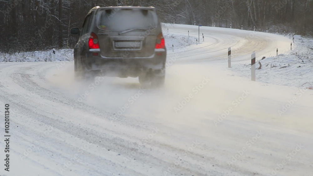 cars move along the snow-covered road in the snow cars move along the snow-covered road in the snow