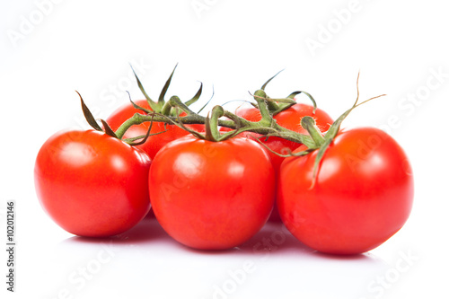fresh tomatoes with green leaves isolated on white background